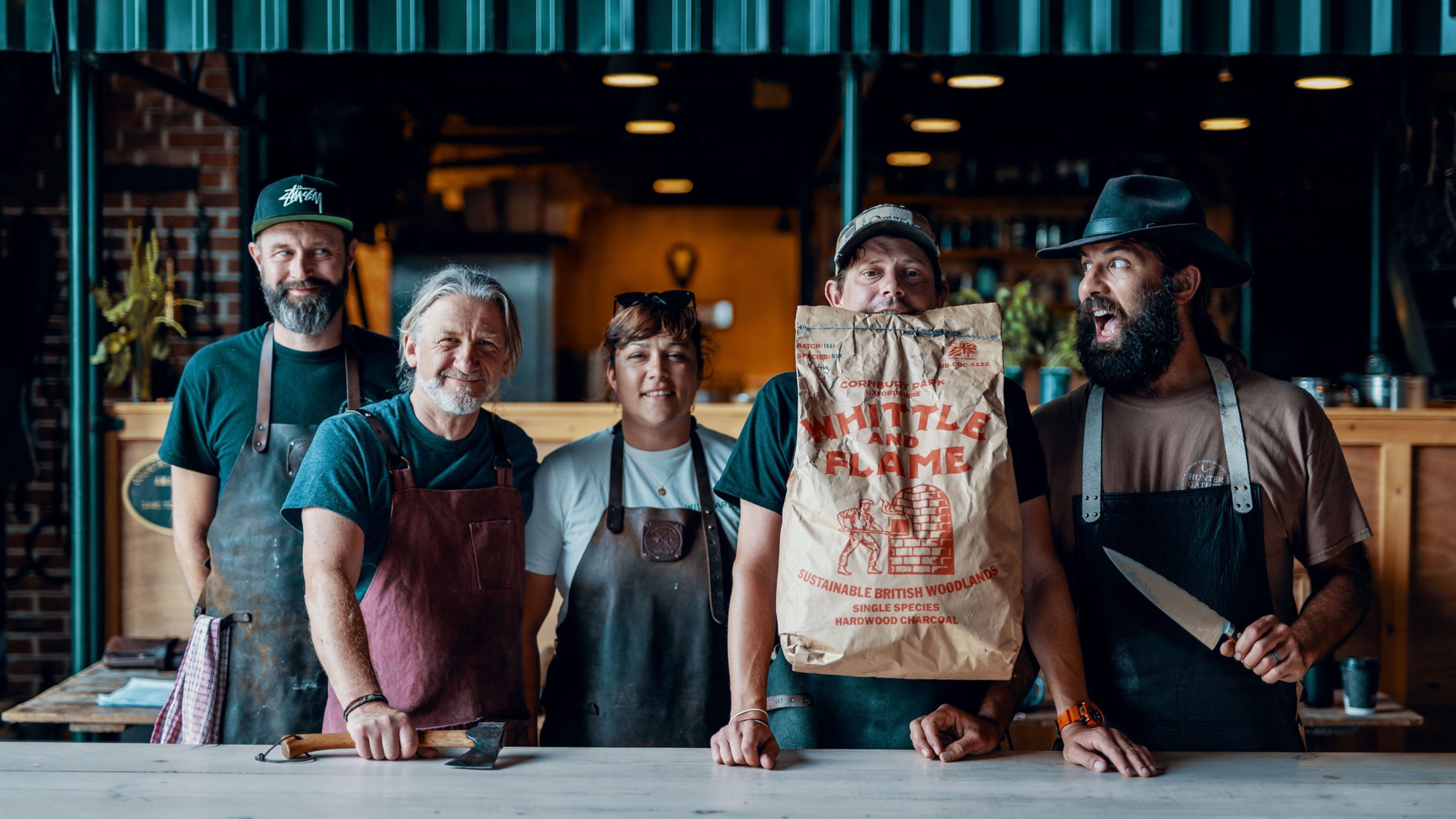Core team photo of five people, standing together looking happy