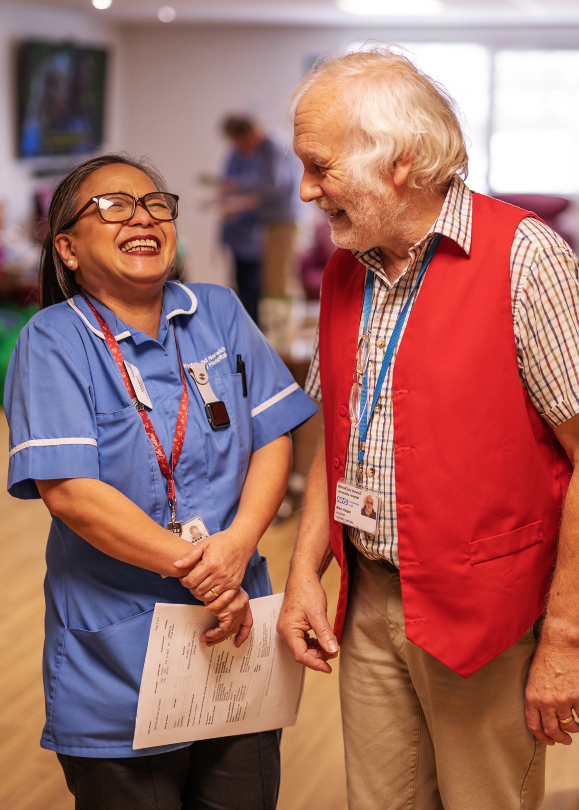 Helpforce male volunteer laughing with a female nurse