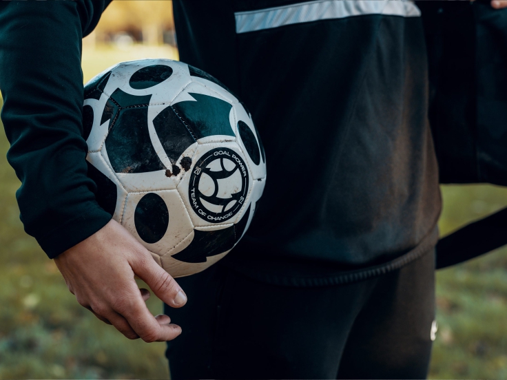 Goal Power ball under the arm of a women