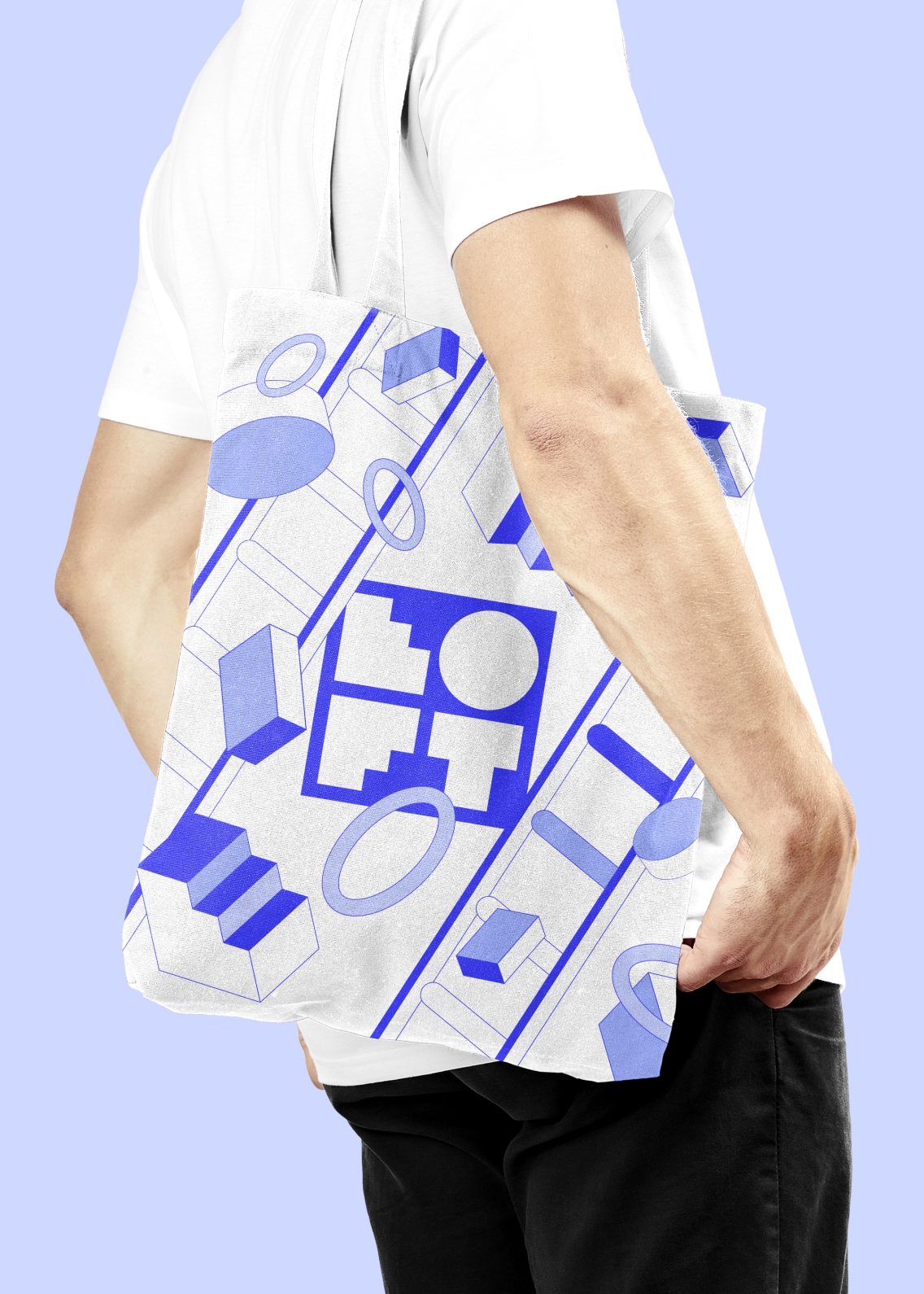 A branded tote bag conceptualisation worn by a man. The Loft logo sits centre as is partially obscured by the brand's graphic shapes floating in the foreground.