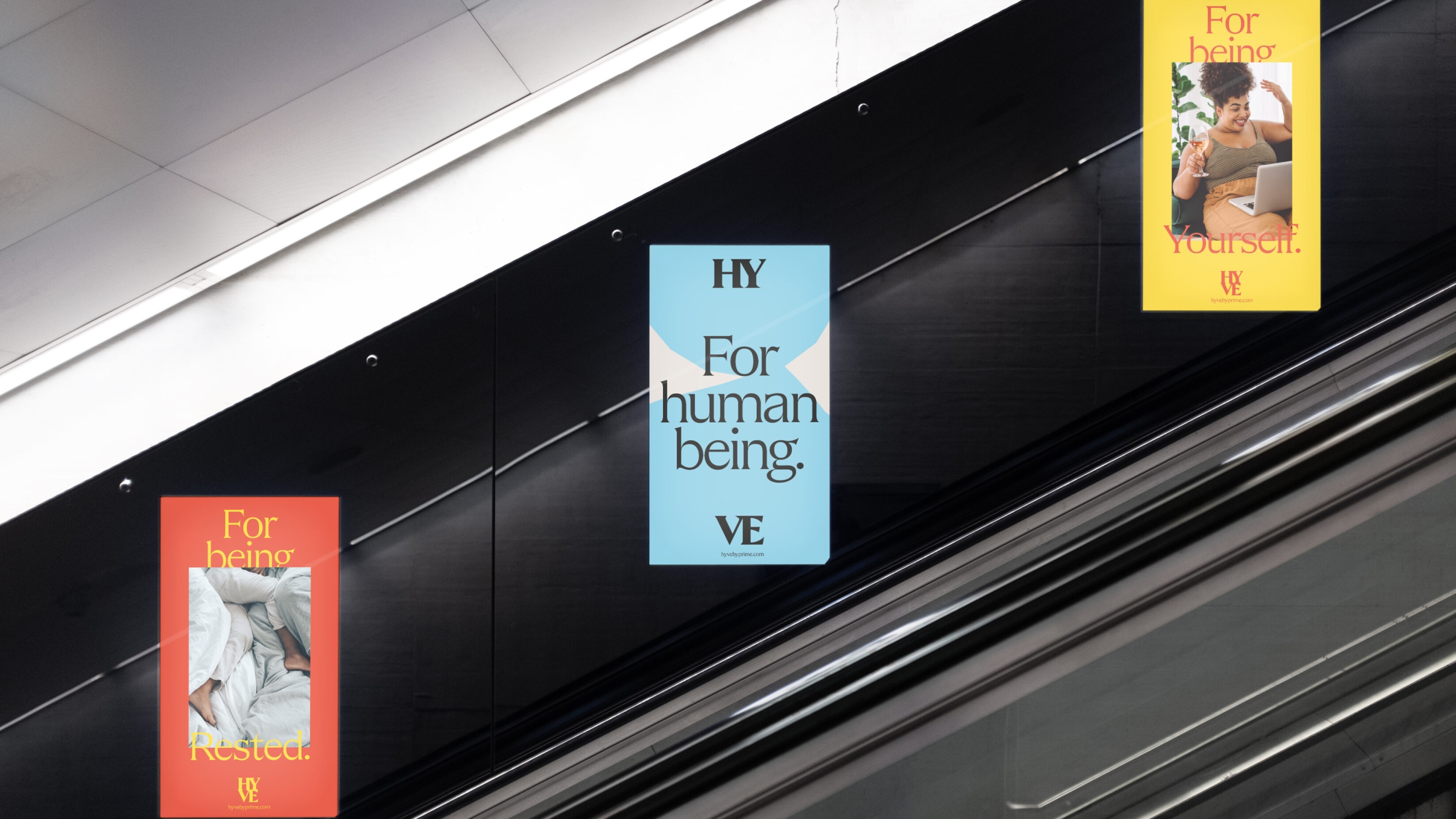 Three escalator posters in various colours, all with a logo and messaging on.