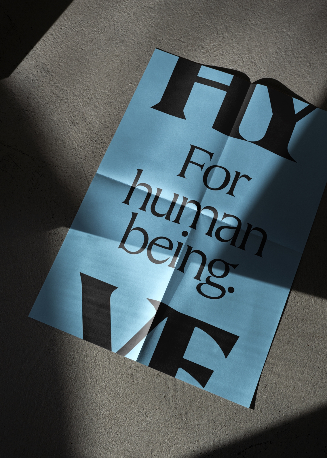 'For human being' large type poster in black on a light blue background, framed with a HY at the top and VE at the bottom.