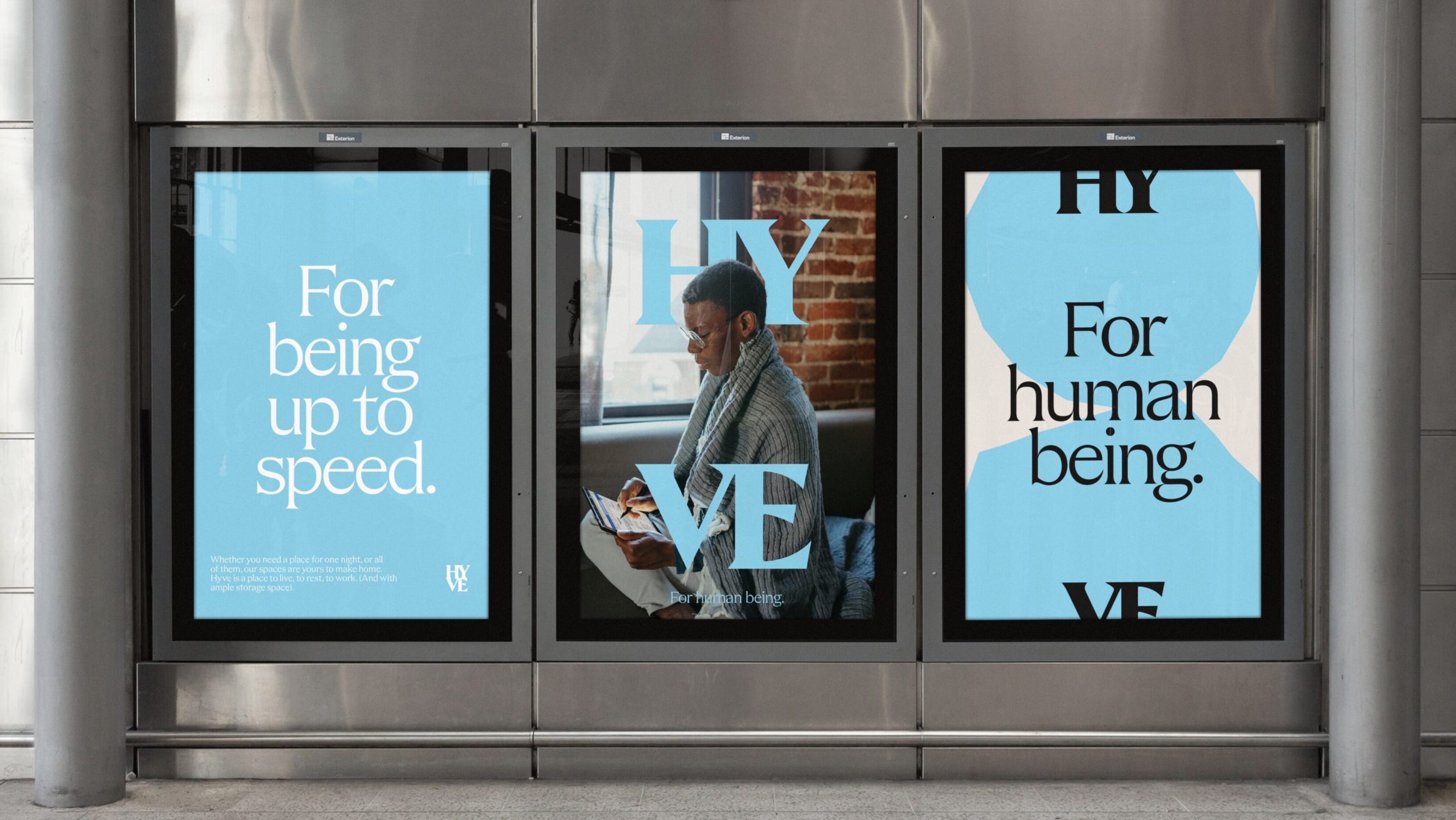 Three digital large format adverts, with the brand strapline 'For human being', and a mature woman working on a tablet.