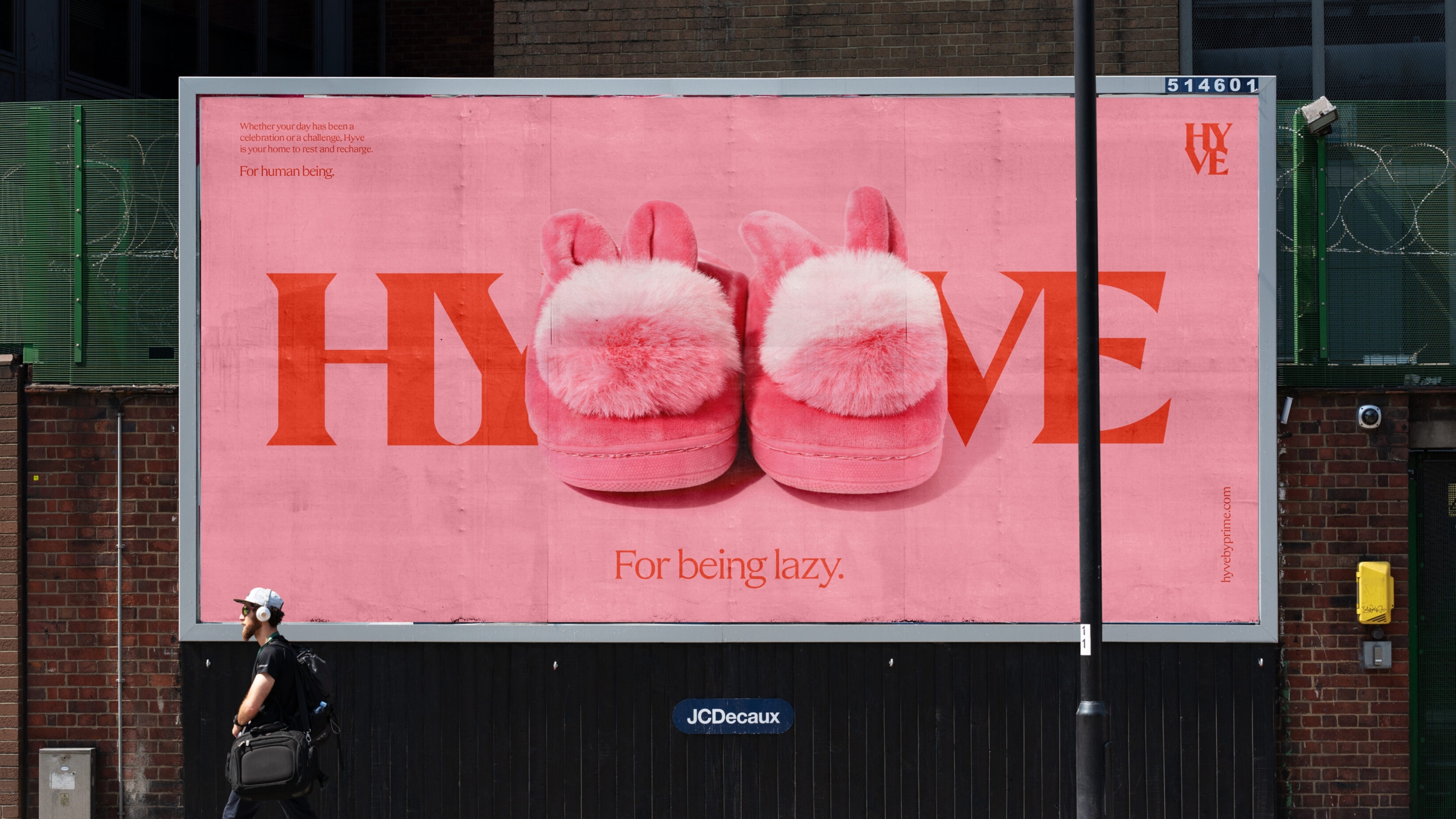 Outdoor billboard, with a large HYVE logo and a pair of pink fluffy slippers in the centre, splitting the wording.