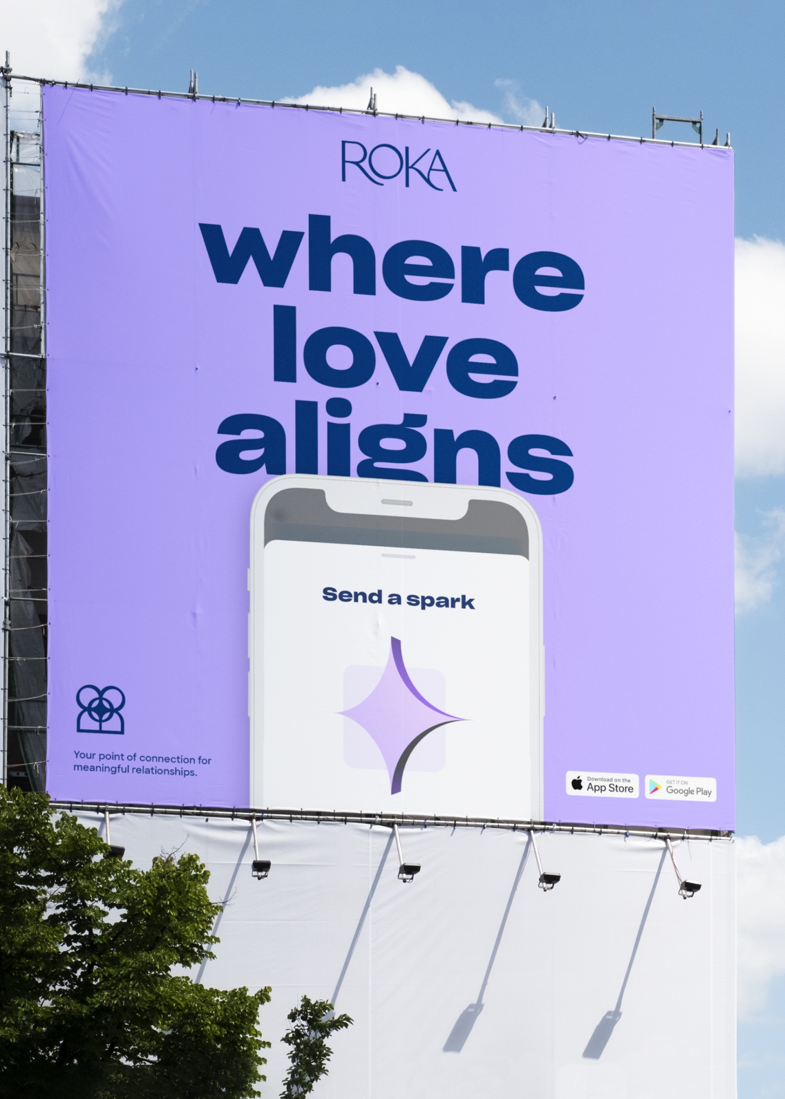 Large outdoor banner with the 'where love aligns' strapline. and mobile phone, on a light purple background
