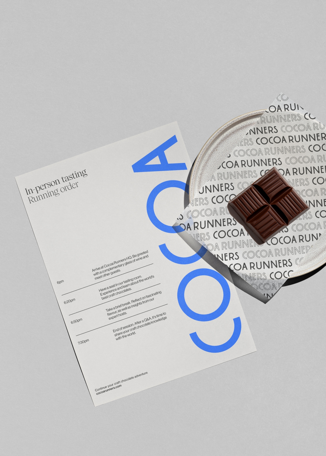 In-person running order sheet, alongside some chocolate on a plate.