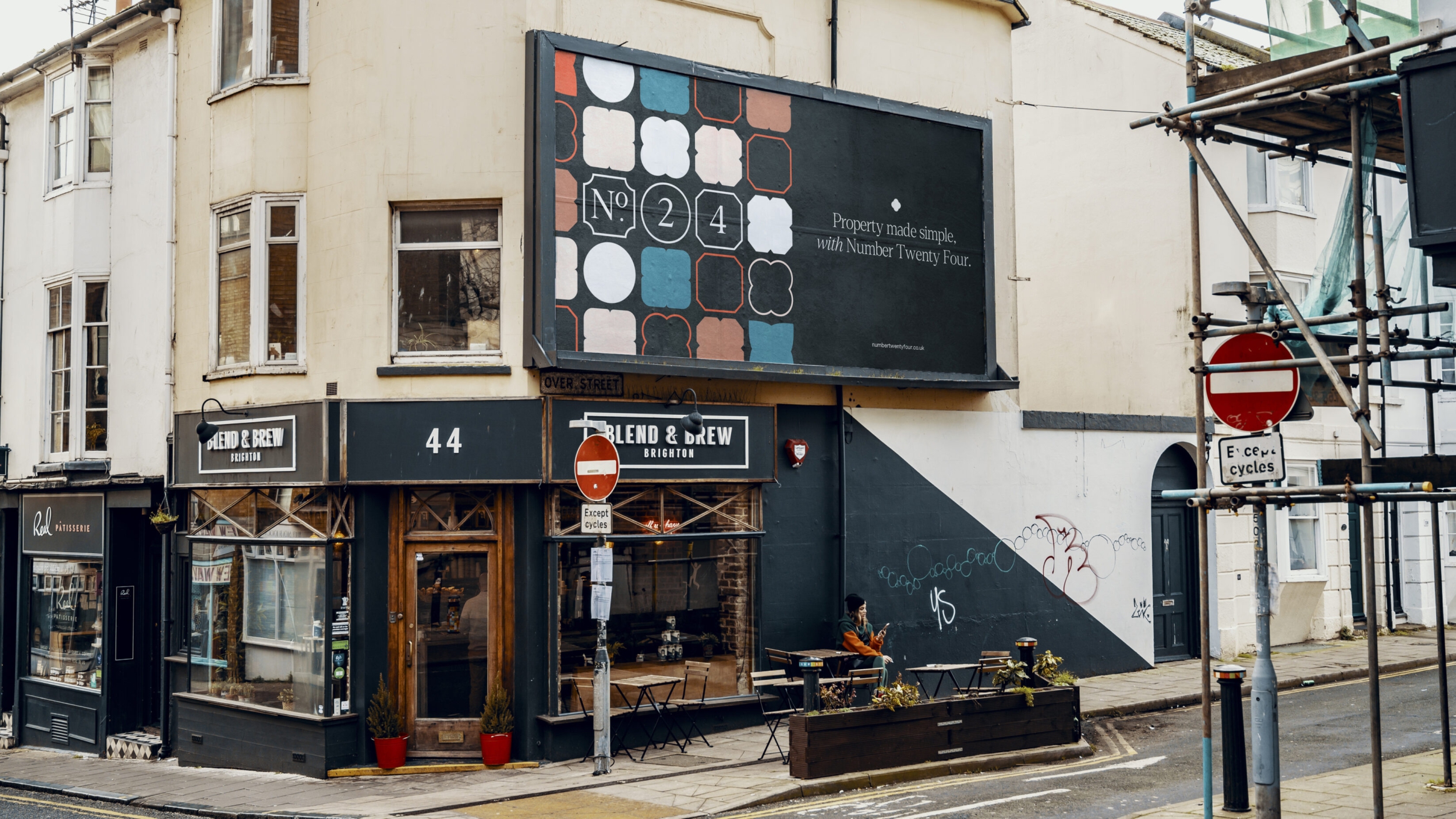 Billboard on a Brighton street, showing the No. 24 logo and the pattern shapes.