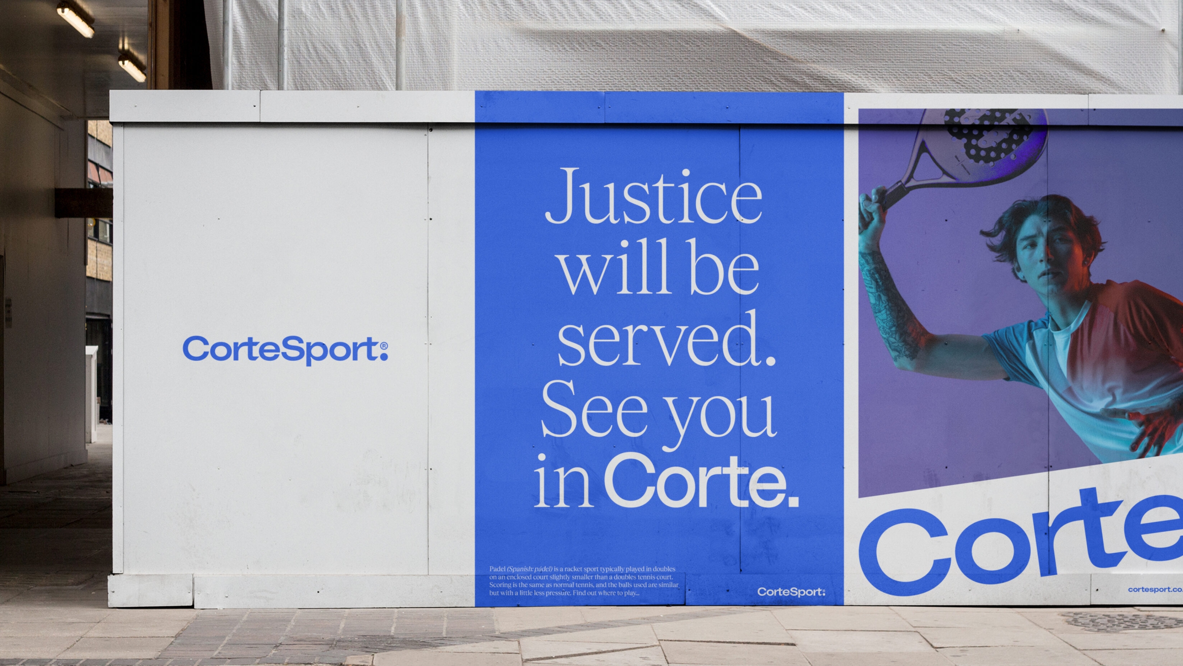 Large construction site hoarding, with 'Justice will be served. See you on Corte' in large type, alongside a padel image.